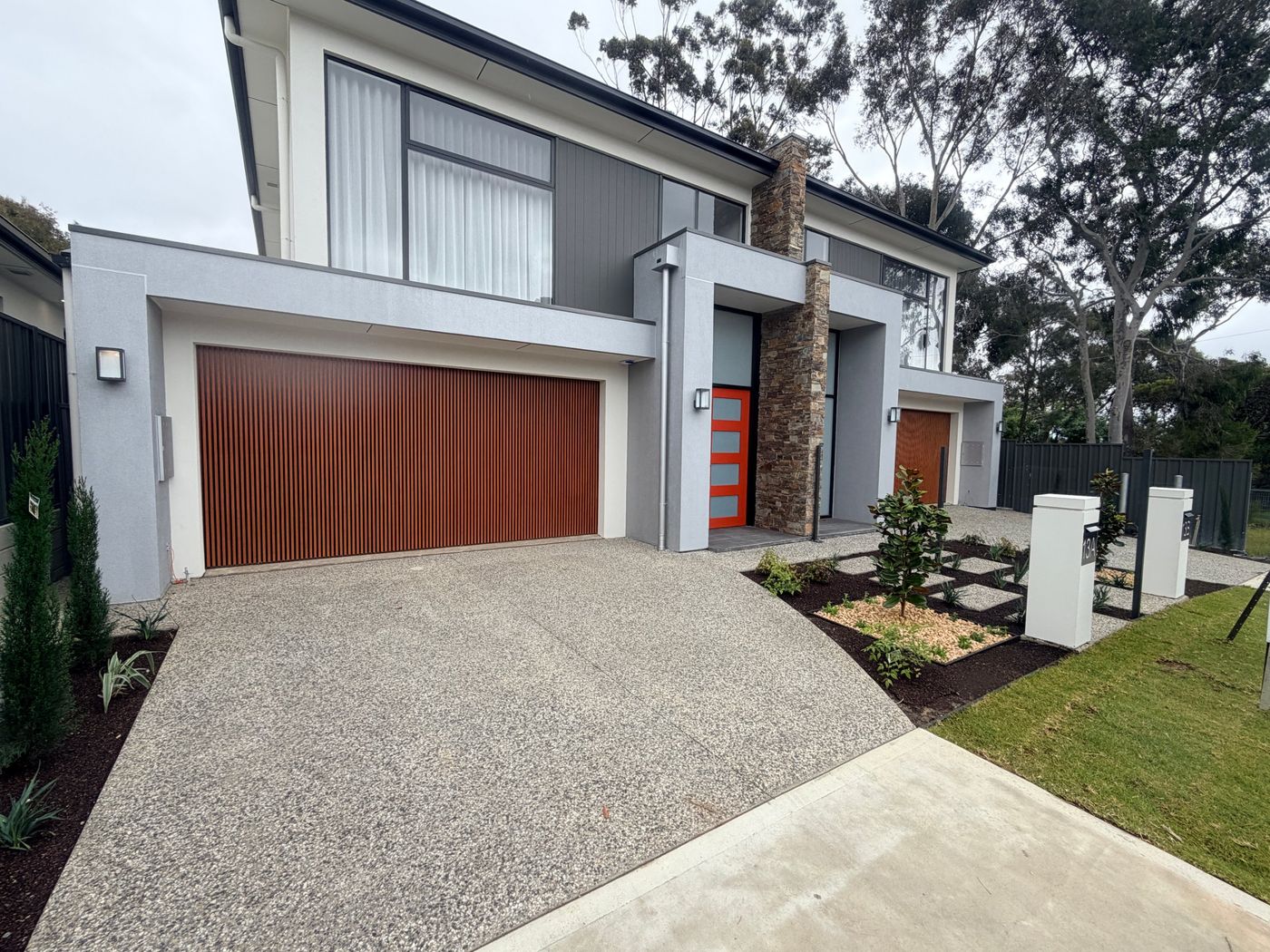 Modern two-storey home with a timber-look garage door