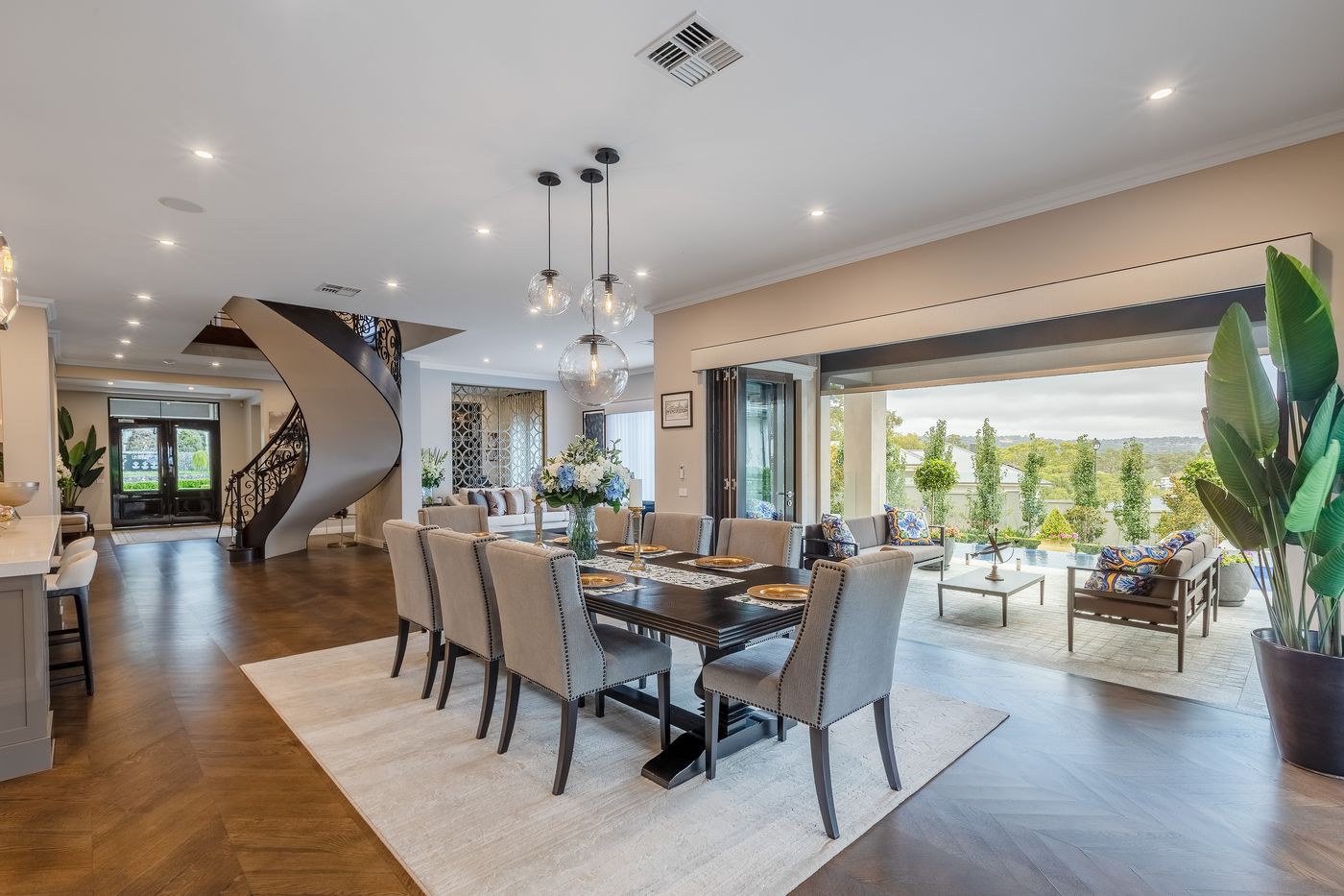 Open-plan dining area with a curved staircase